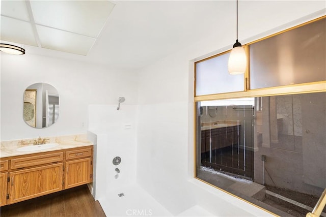 bathroom featuring vanity, a bathtub, and hardwood / wood-style flooring