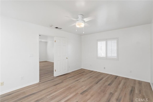 empty room featuring ceiling fan and light wood-type flooring