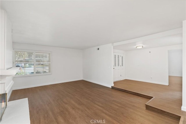 unfurnished living room with dark hardwood / wood-style floors