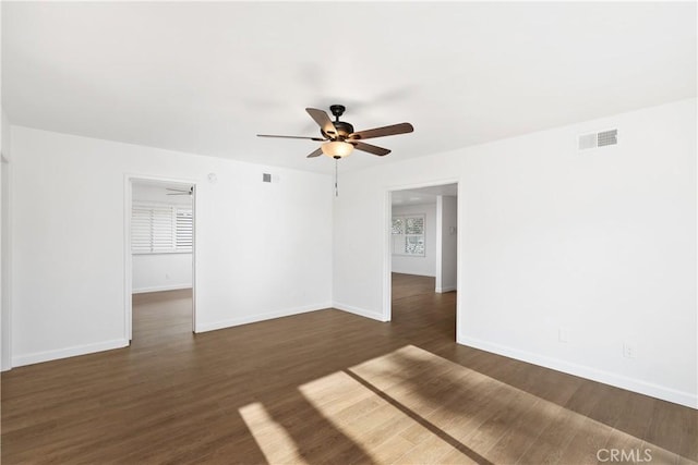 empty room with dark wood-type flooring and ceiling fan