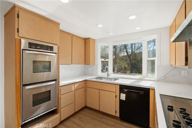 kitchen featuring exhaust hood, backsplash, sink, black dishwasher, and stainless steel double oven