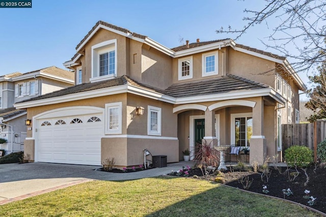 front facade featuring a porch, a garage, and a front lawn