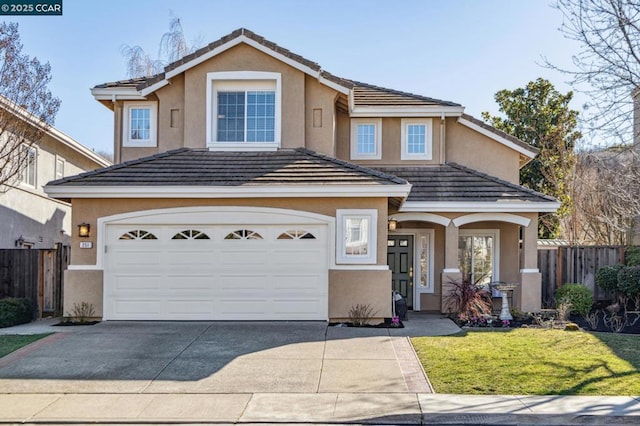 front facade featuring a garage and a front lawn