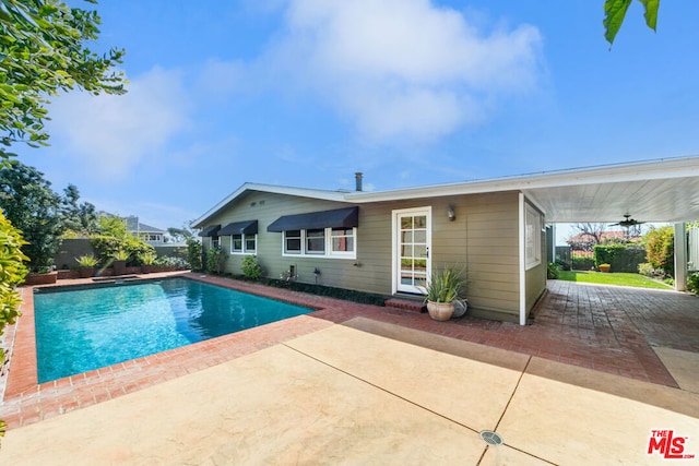 view of swimming pool featuring ceiling fan and a patio area