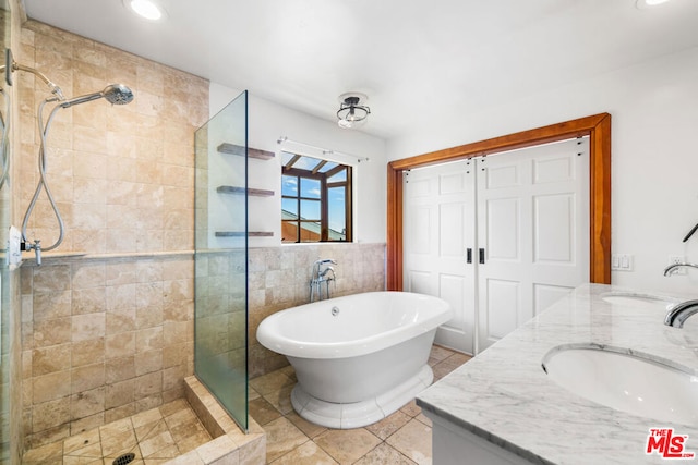 bathroom with shower with separate bathtub, tile patterned floors, and vanity