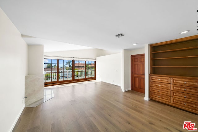 unfurnished room with wood-type flooring