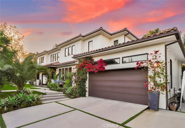 mediterranean / spanish home featuring a garage