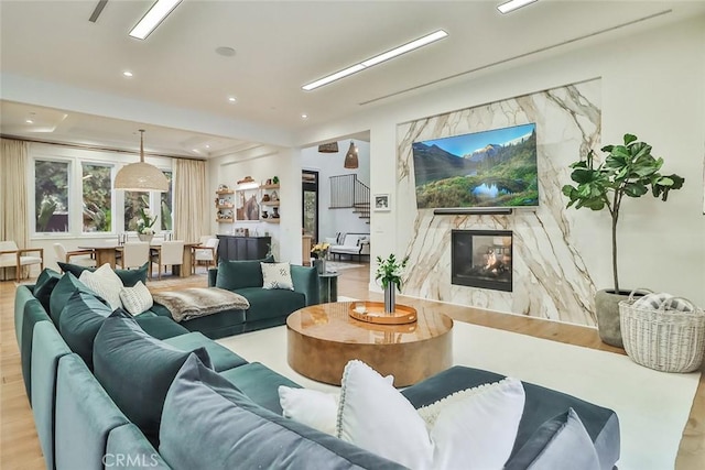 living room featuring light hardwood / wood-style flooring and a fireplace