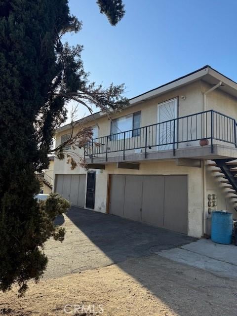 view of front of house with a balcony and a garage