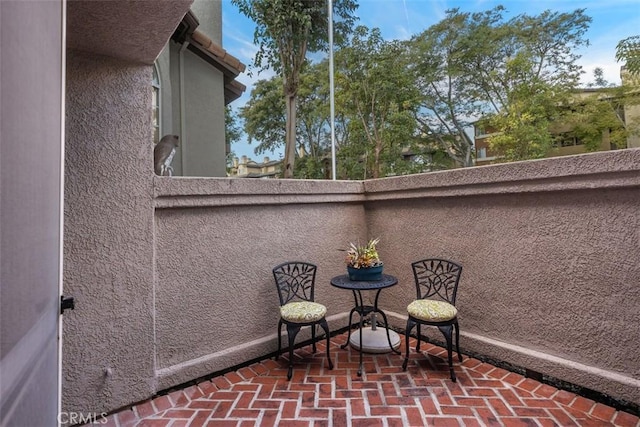 view of patio featuring a balcony