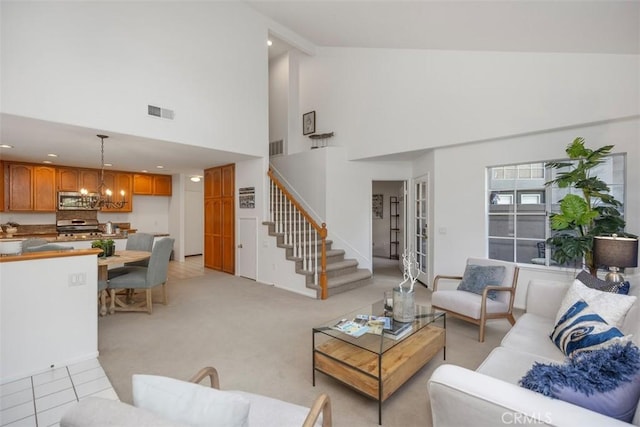 living room featuring an inviting chandelier, high vaulted ceiling, and light tile patterned floors