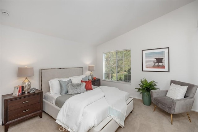 bedroom featuring vaulted ceiling and light carpet