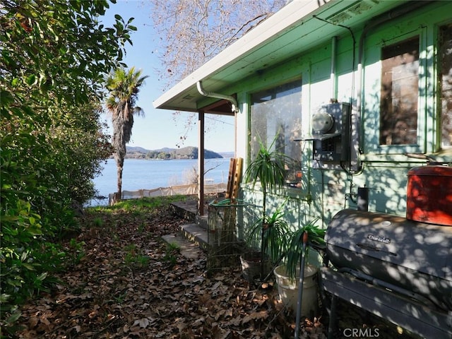 view of side of home featuring a water view