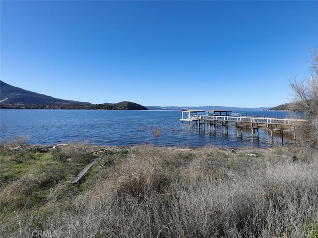 dock area featuring a water and mountain view