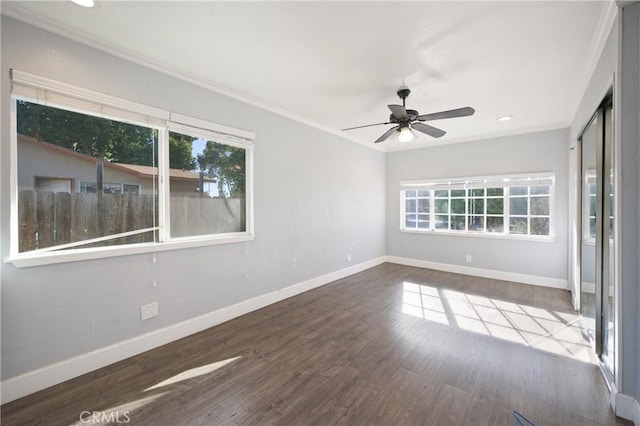 spare room featuring ceiling fan, dark wood-type flooring, and ornamental molding