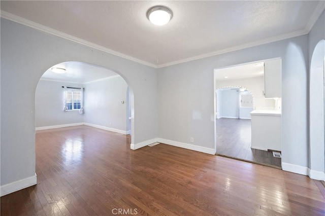 unfurnished room with crown molding and hardwood / wood-style flooring