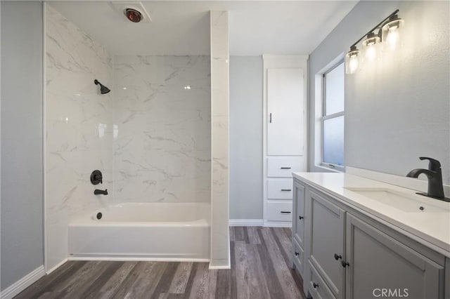 bathroom featuring tiled shower / bath combo, wood-type flooring, and vanity