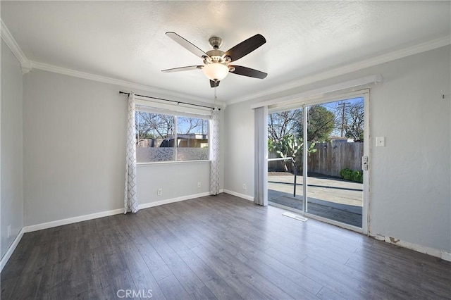 empty room with dark wood-type flooring, a wealth of natural light, and crown molding