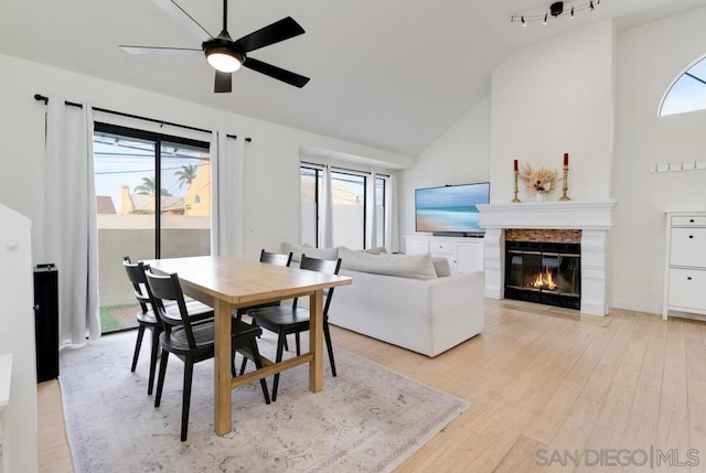 dining room featuring light hardwood / wood-style flooring, vaulted ceiling, and ceiling fan