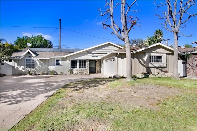 single story home featuring a front yard and a garage