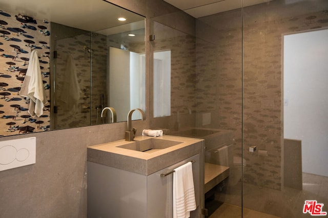 bathroom featuring vanity and tile walls