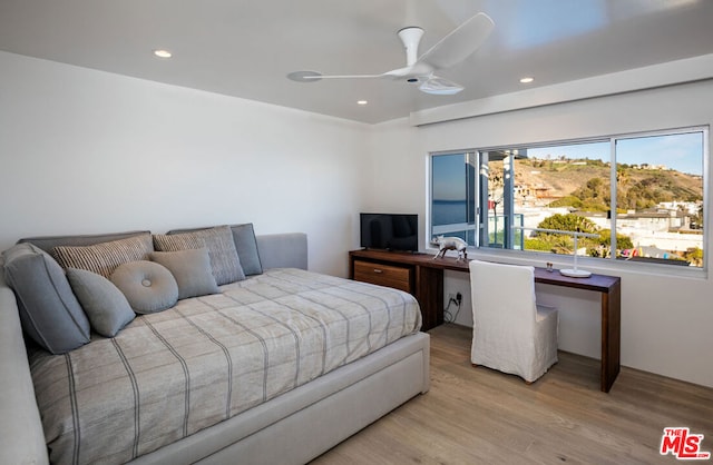 bedroom featuring ceiling fan and light hardwood / wood-style flooring