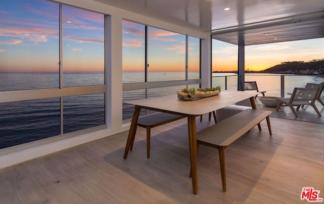 sunroom / solarium featuring a water view