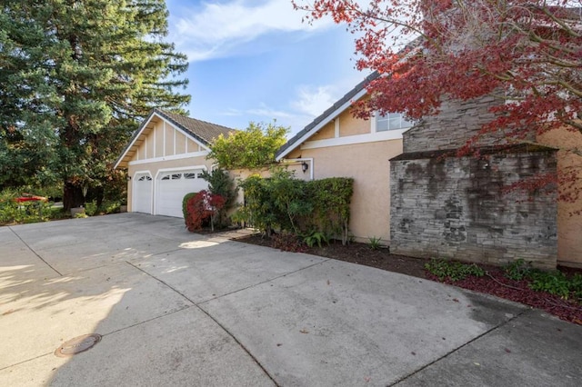 view of side of home featuring a garage