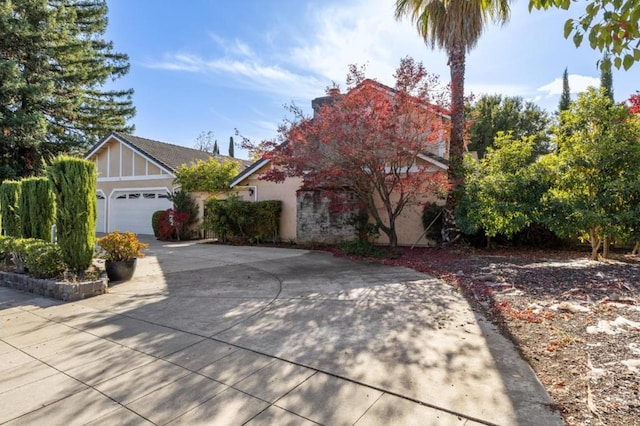 view of property hidden behind natural elements featuring a garage