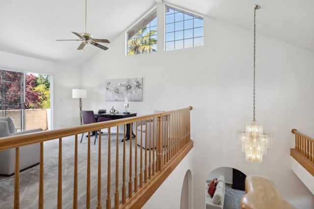 hall with high vaulted ceiling and an inviting chandelier