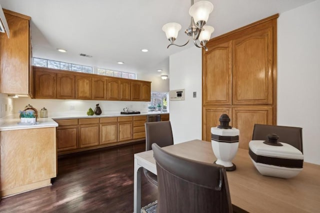 dining room with dark hardwood / wood-style floors and a chandelier