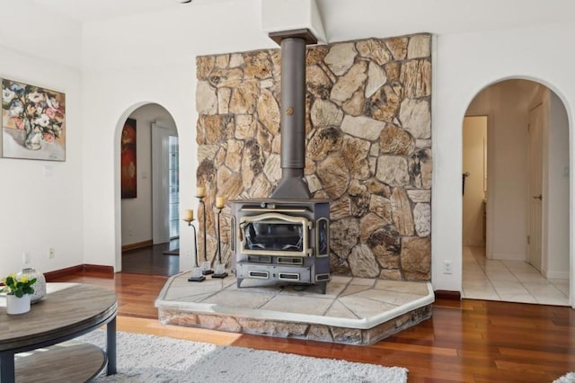 living room with dark hardwood / wood-style flooring and a wood stove