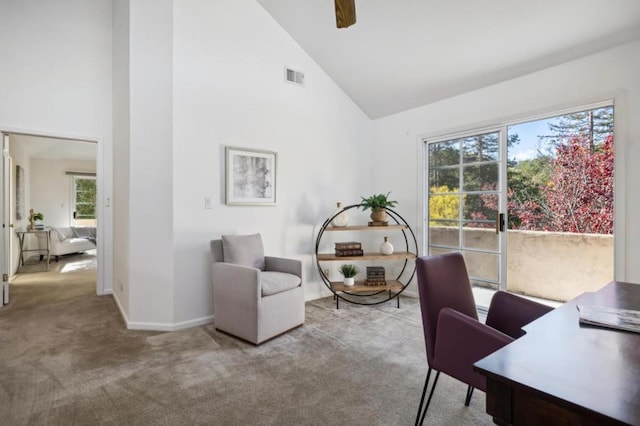 carpeted office featuring ceiling fan, plenty of natural light, and high vaulted ceiling