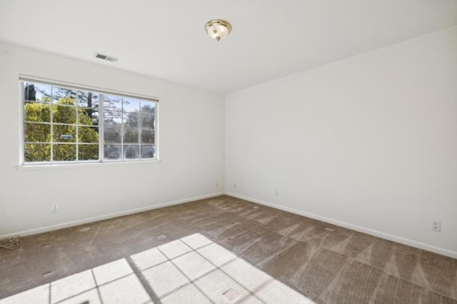 unfurnished room featuring light carpet