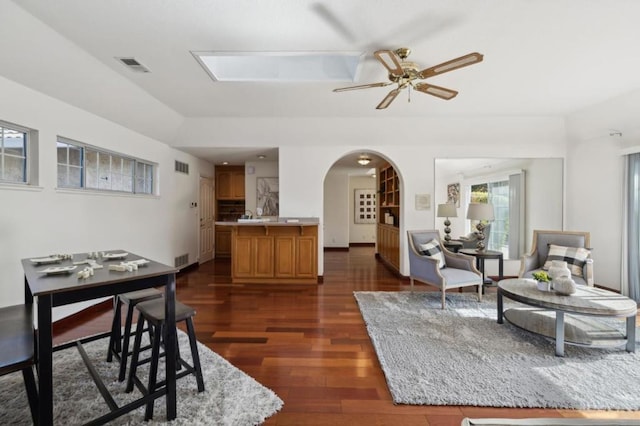 living room featuring dark hardwood / wood-style floors and ceiling fan