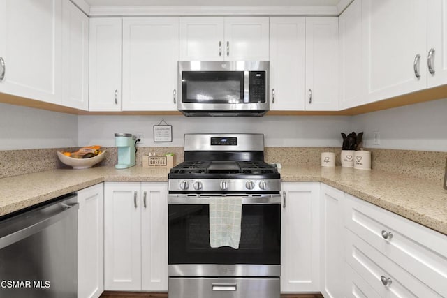 kitchen featuring light stone counters, white cabinetry, and appliances with stainless steel finishes