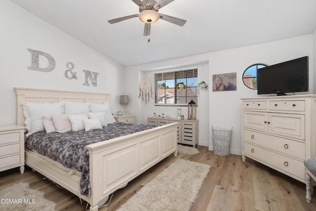 bedroom with ceiling fan, lofted ceiling, and light hardwood / wood-style flooring