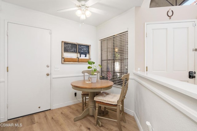 dining space with ceiling fan, ornamental molding, and light hardwood / wood-style flooring