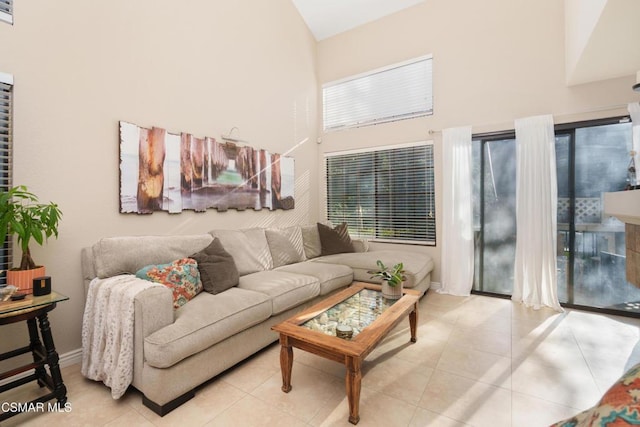 tiled living room featuring a towering ceiling