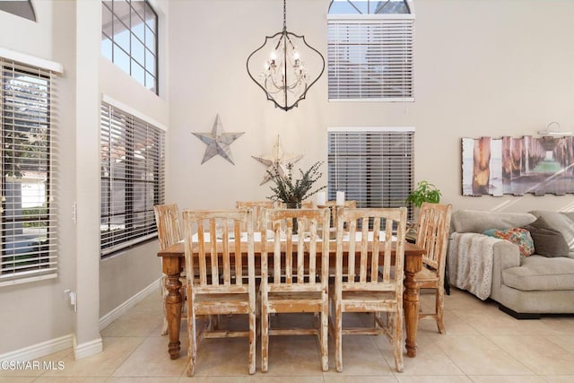 dining space featuring a healthy amount of sunlight, an inviting chandelier, and light tile patterned flooring