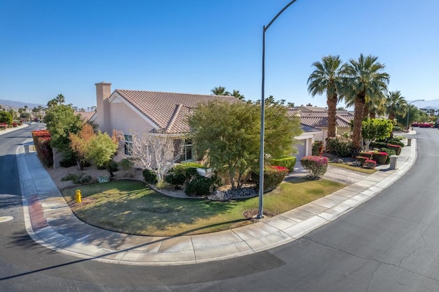 view of front of home featuring a garage and a front yard