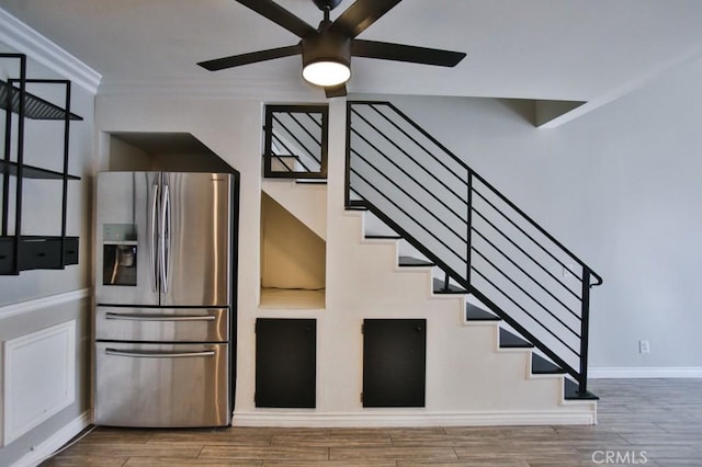 staircase featuring ceiling fan and ornamental molding