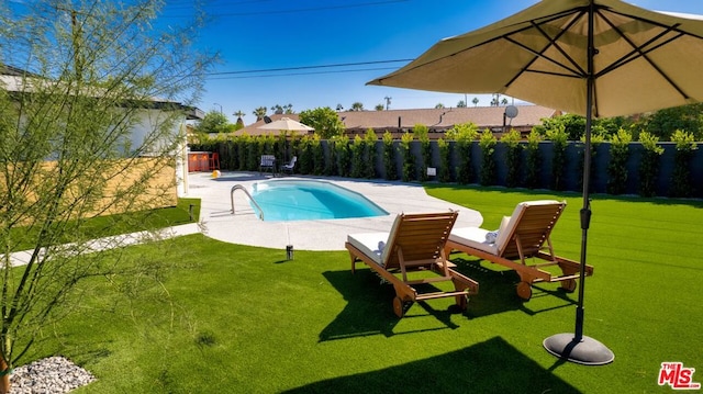 view of swimming pool with a lawn and a patio