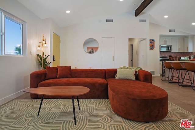 living room featuring vaulted ceiling with beams