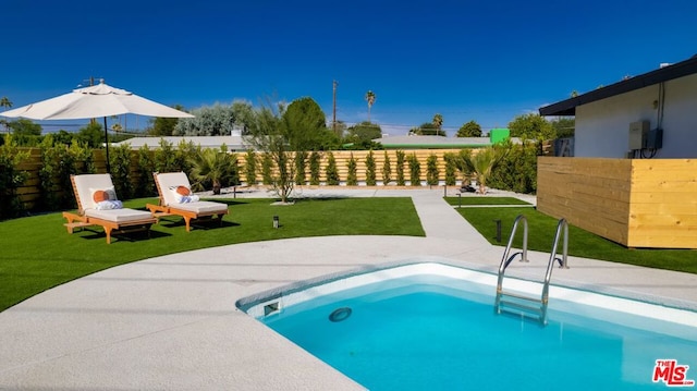 view of pool featuring a yard