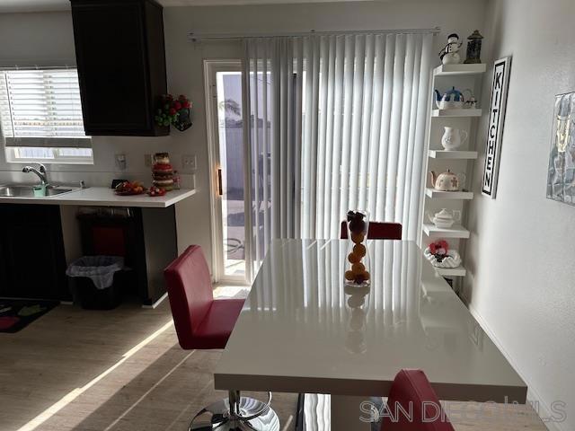 dining room with sink and light hardwood / wood-style flooring