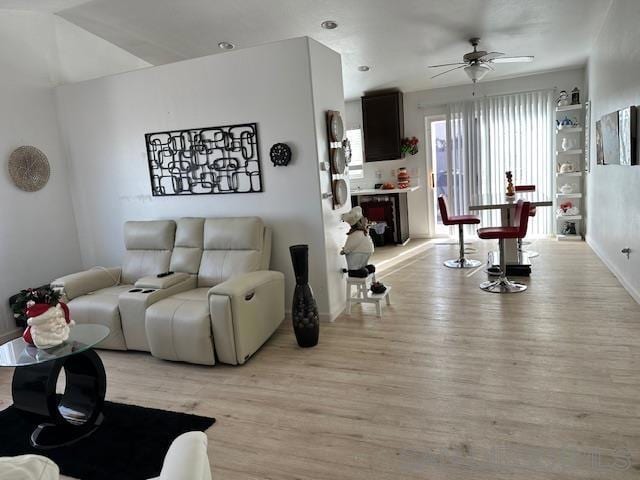 living room featuring ceiling fan and light hardwood / wood-style flooring