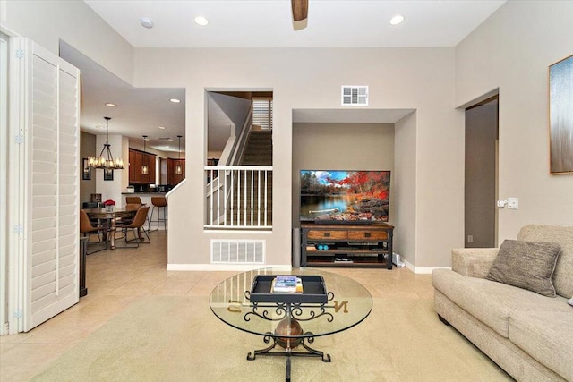 living room featuring light tile patterned flooring and an inviting chandelier