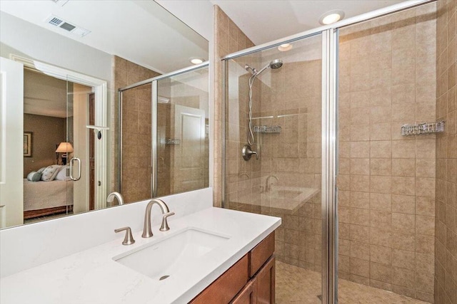 bathroom with walk in shower and vanity