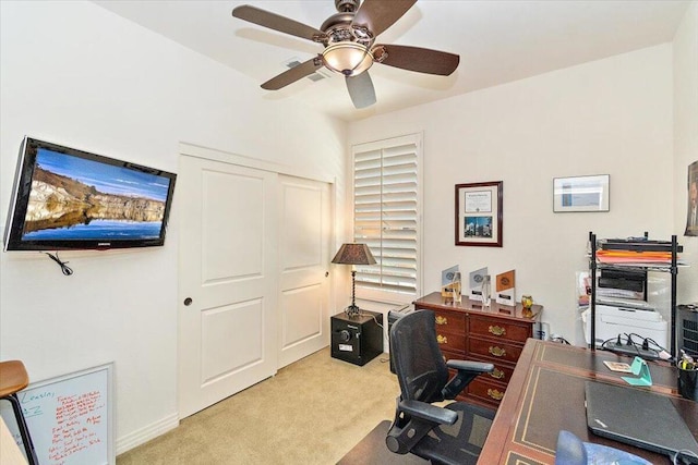 carpeted home office with ceiling fan